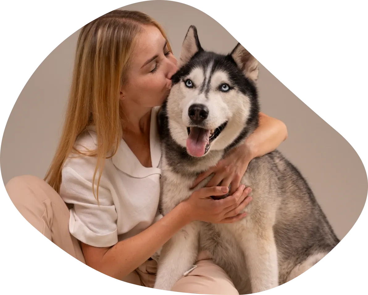 Woman kissing her husky