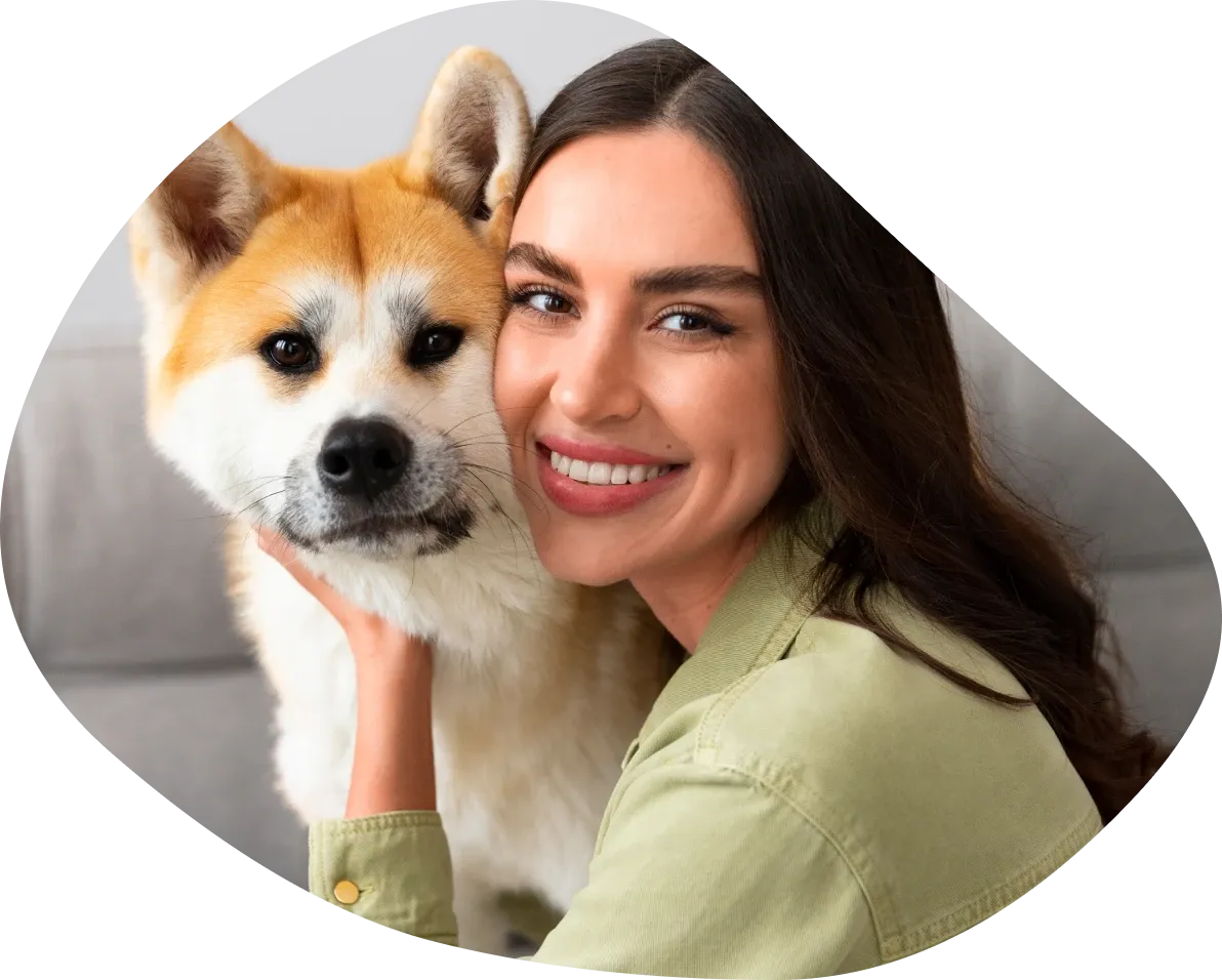 Smiling woman cuddling her akita